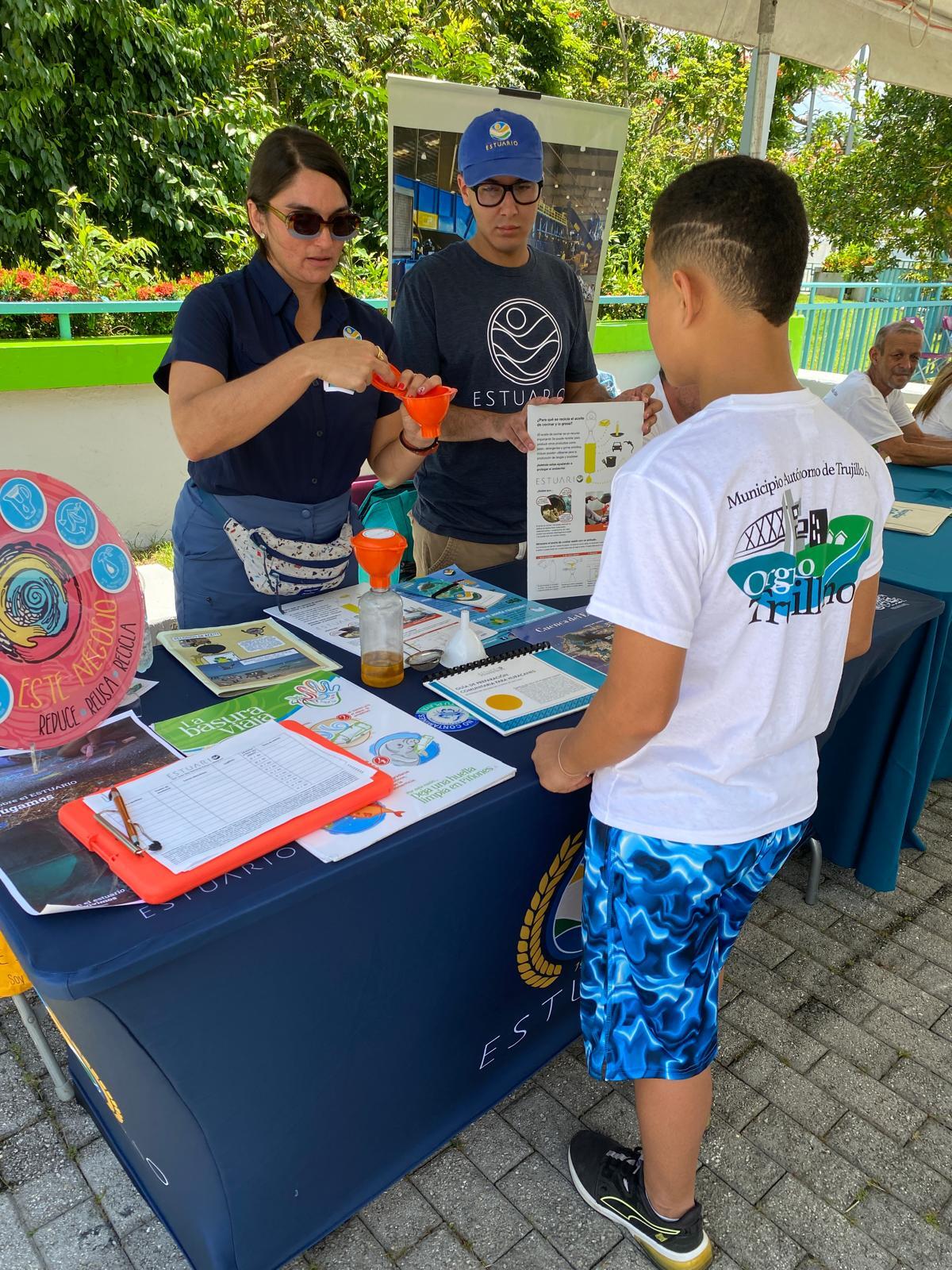 Asistentes visitan las diversas estaciones informativas donde aprenden sobre reciclaje, compostaje y prácticas sostenibles.